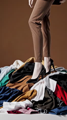person standing on a pile of clothes