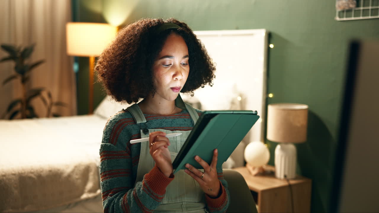 Woman using tablet in bedroom