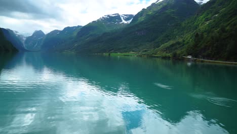 beautiful norway scandinavian landscape with blue lake reflection stones bounce in mountain scenery