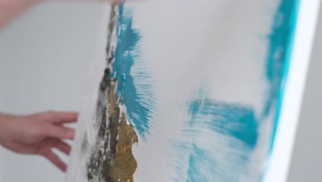 the artist prepares the paints for writing the nartina an artist works on an abstract oil painting - the artist prepares the paints for writing the nartina. an artist works on an abstract oil painting in a workshop. the concept of painting a picture