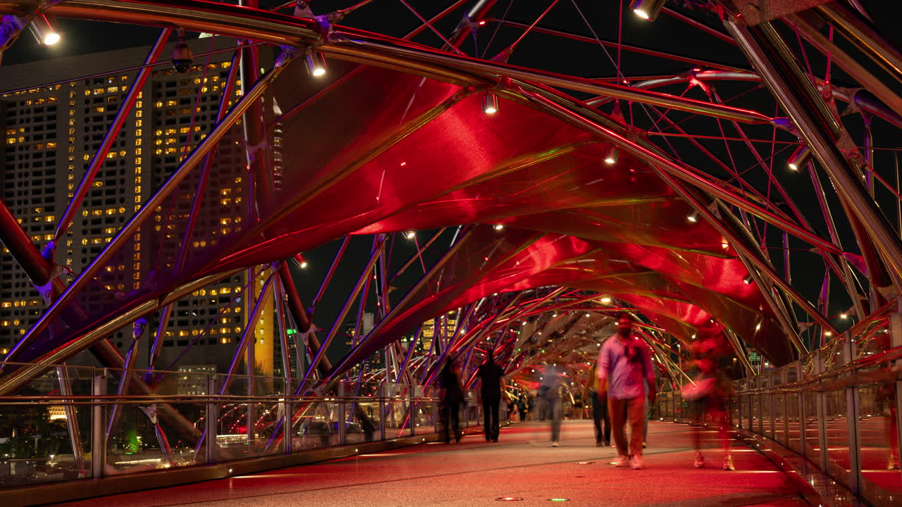 SINGAPORE - 5 MARCH 2025 : timelapse of the helix foot bridge in singapore marina bay at night