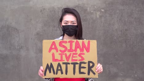 asian woman with poster during protest against sexual harassment