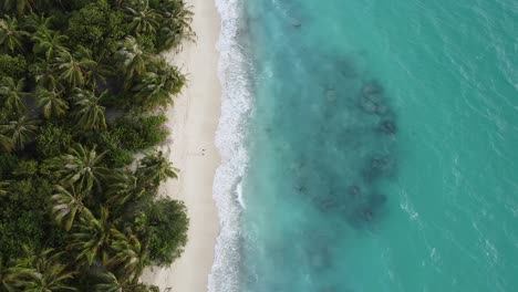 aerial view of a tropical island with a white sand beach and turquoise waters