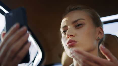 confident business woman having video call on mobile phone at car