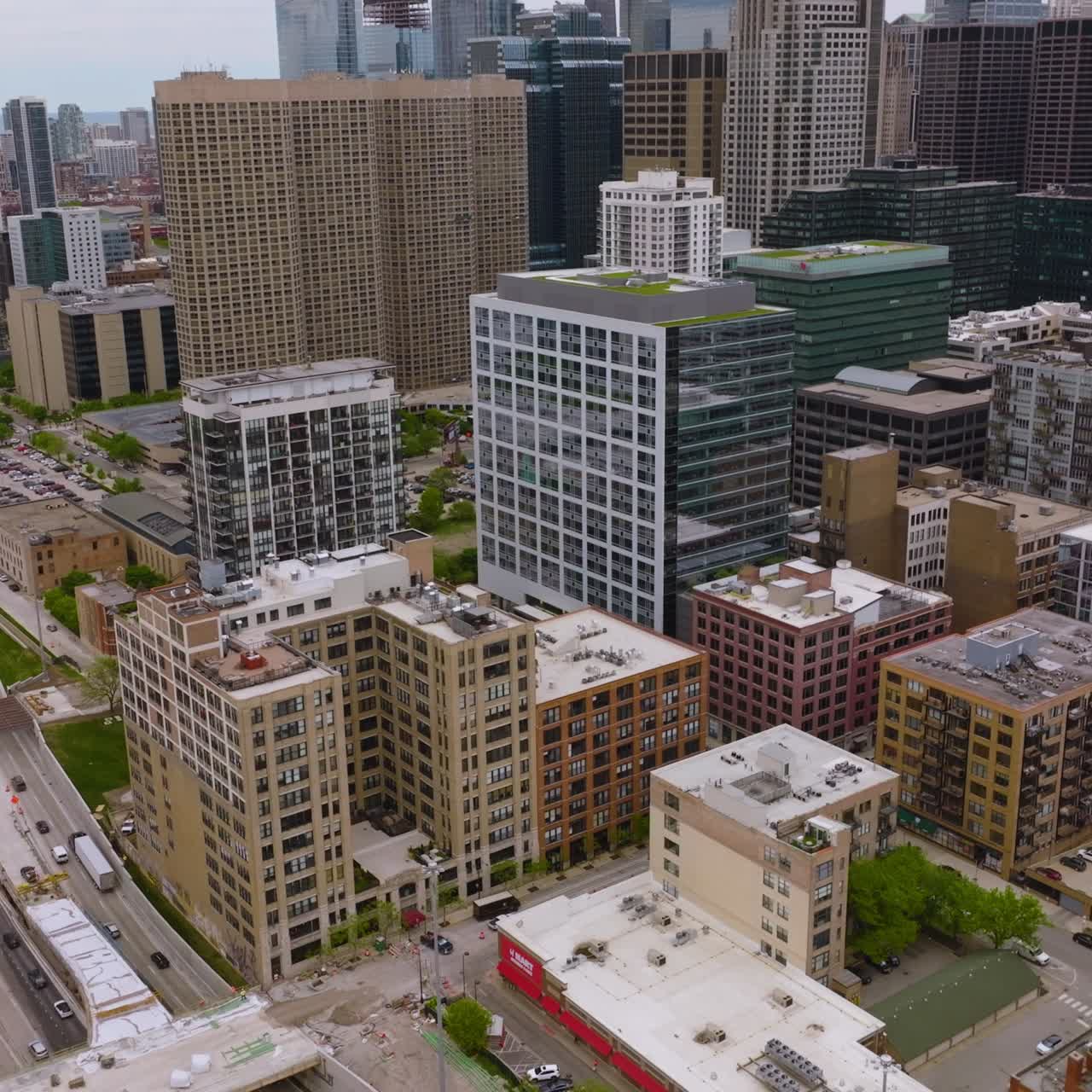 Metropolis lively traffic at daytime. Mulyi0lane highways filled with transport at the backdrop of diverse architecture