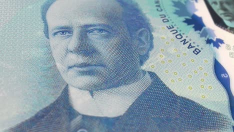 canada canadian dollars 5 banknotes, five canadian dollars, close-up and macro view of the canadian dollars, tracking and dolly shots 5 canadian dollars banknote observe and reserve side, canadian dollar money currency background, loopable moving image