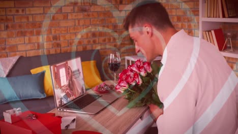 Concentric-hearts-over-caucasian-man-holding-a-flower-bouquet-while-having-a-video-call-on-laptop