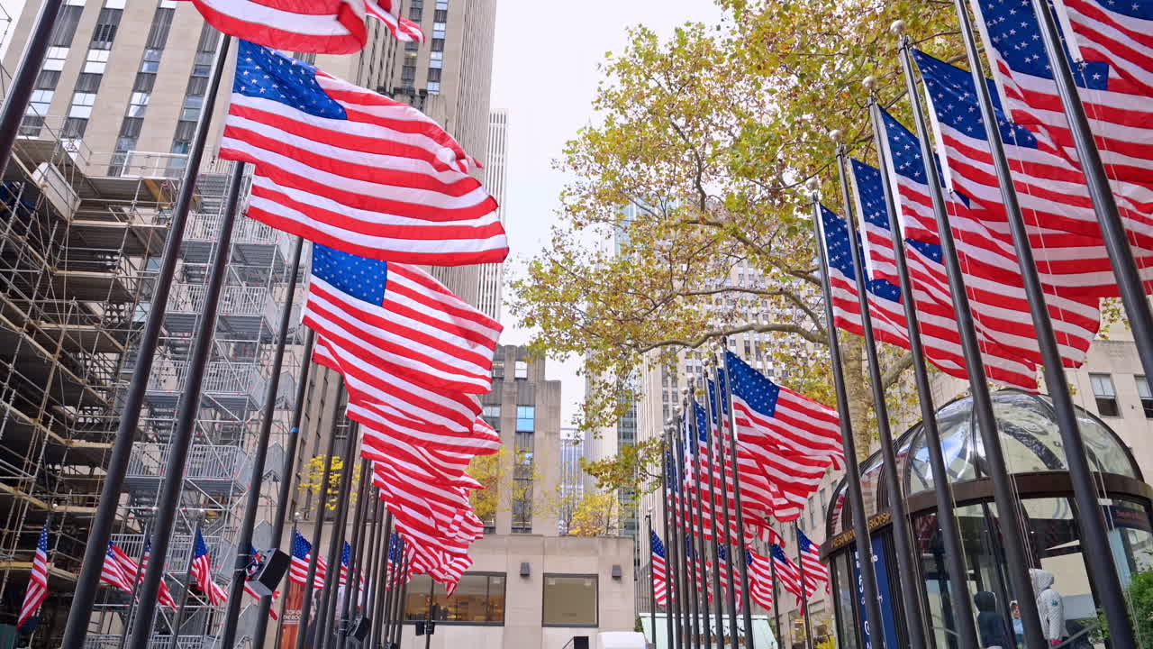 New York, USA, 12 December 2025: Rockefeller Center flag walkway. Visitors walk between American flags at Rockefeller Center in fall season