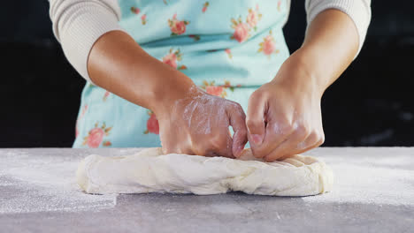 Woman-kneading-a-dough-4k