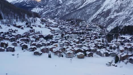 aerial dolly of beautiful small snow covered town in the mountains