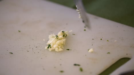 chopping garlic with gloves