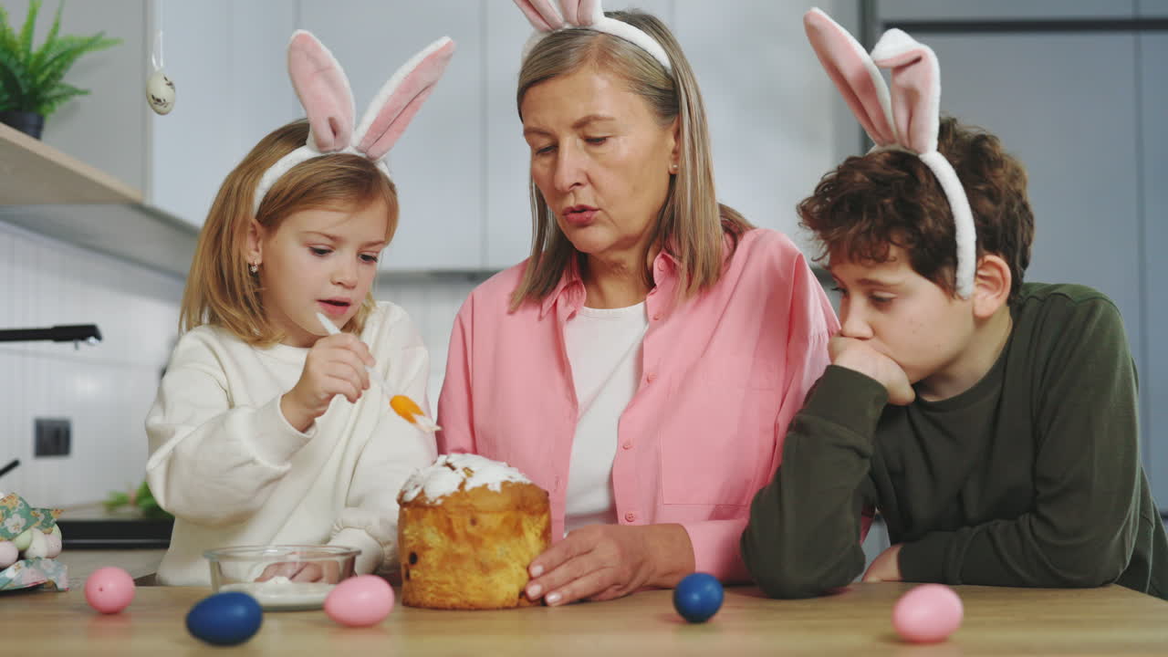 Grandmother and Grandchildren Decorate Easter Cake
