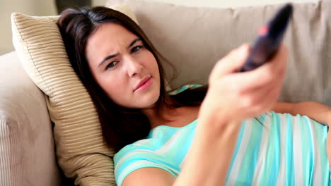 Pretty-brunette-relaxing-on-the-sofa-watching-tv