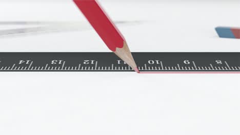 red pencil draws a line along the ruler