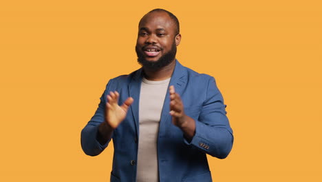 joyful man happily clapping hands, ecstatic, studio background