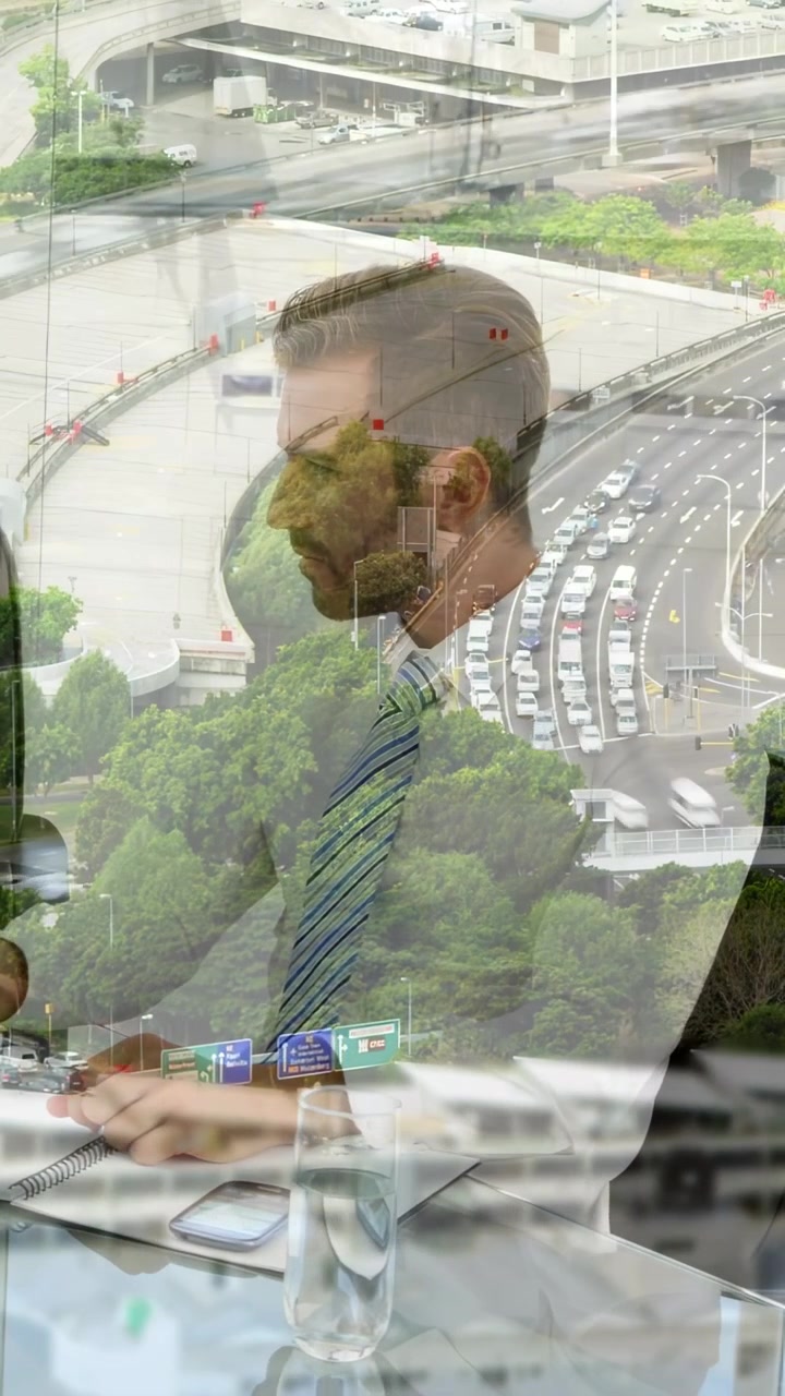 Vertical video: Exec taking notes for record in business as peer tapping phone causing road overlay