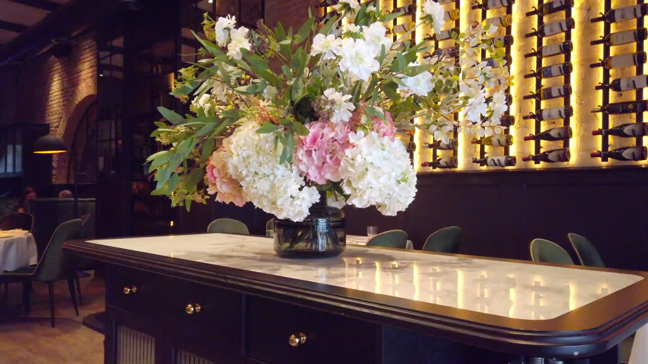 A bouquet of flowers on a table at a restaurant