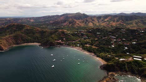 drone flying backwards from high revealing volcanic tropical coastal landscape of guanacaste, costa rica