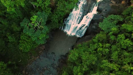 incredible establishing tilting aerial shot of stunning waterfall in wild jungle, minas gerais brazil