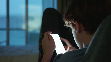 teenager using smartphone at night