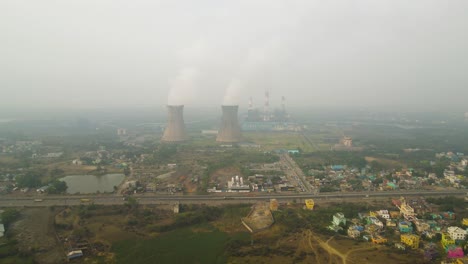 high-altitude aerial shot of indian industries, with smoky emissions visible from numerous stacks.