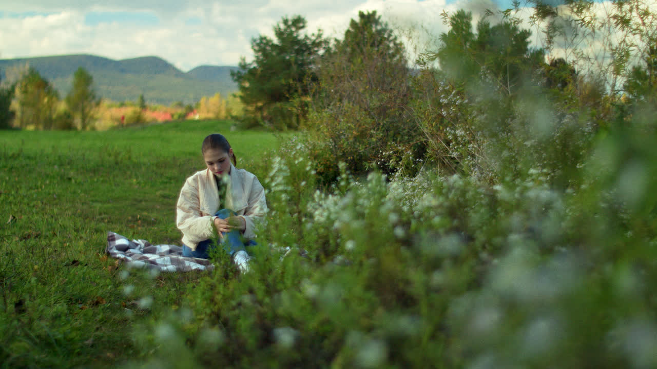 Woman Sitting in a Park on a Fall Day