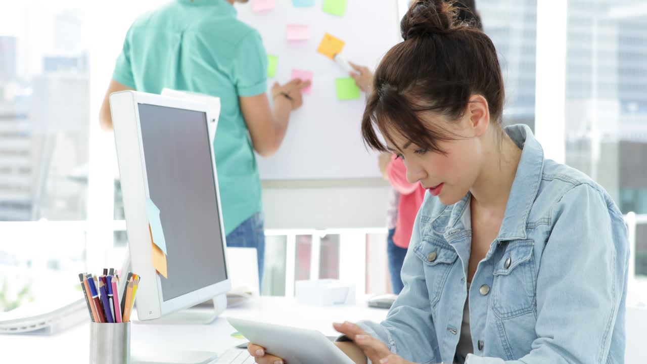 Gorgeous creative designer working on her tablet 