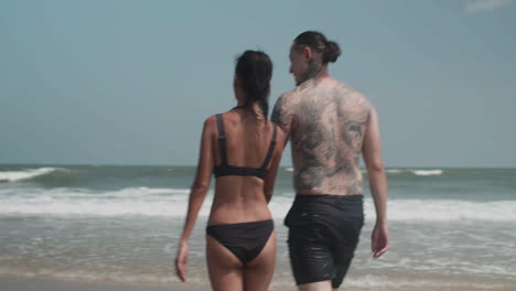 Couple-going-into-the-water