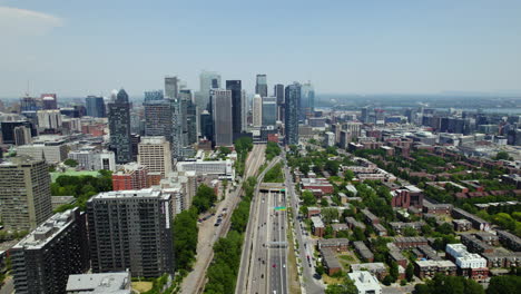 aerial view backwards along the boulevard ville-marie, in sunny montreal, canada