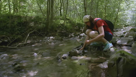 woman hiking in a forest creek