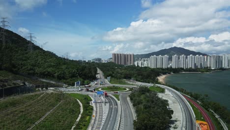 a tilt up shot of the highway in tuen mun where cars are seen passing by