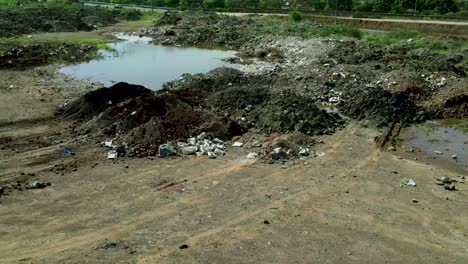 aerial flyover dumping waste, plastic, trash dump and stagnant dirty water