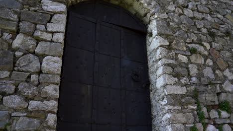 iron heavy locked door of stone building located inside medieval castle