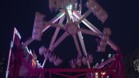 a large swing at a fair in the hague is entertaining people while rocking back and forth