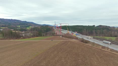 Agricultural-Land-With-Road-Bridge-Construction-In-The-Background