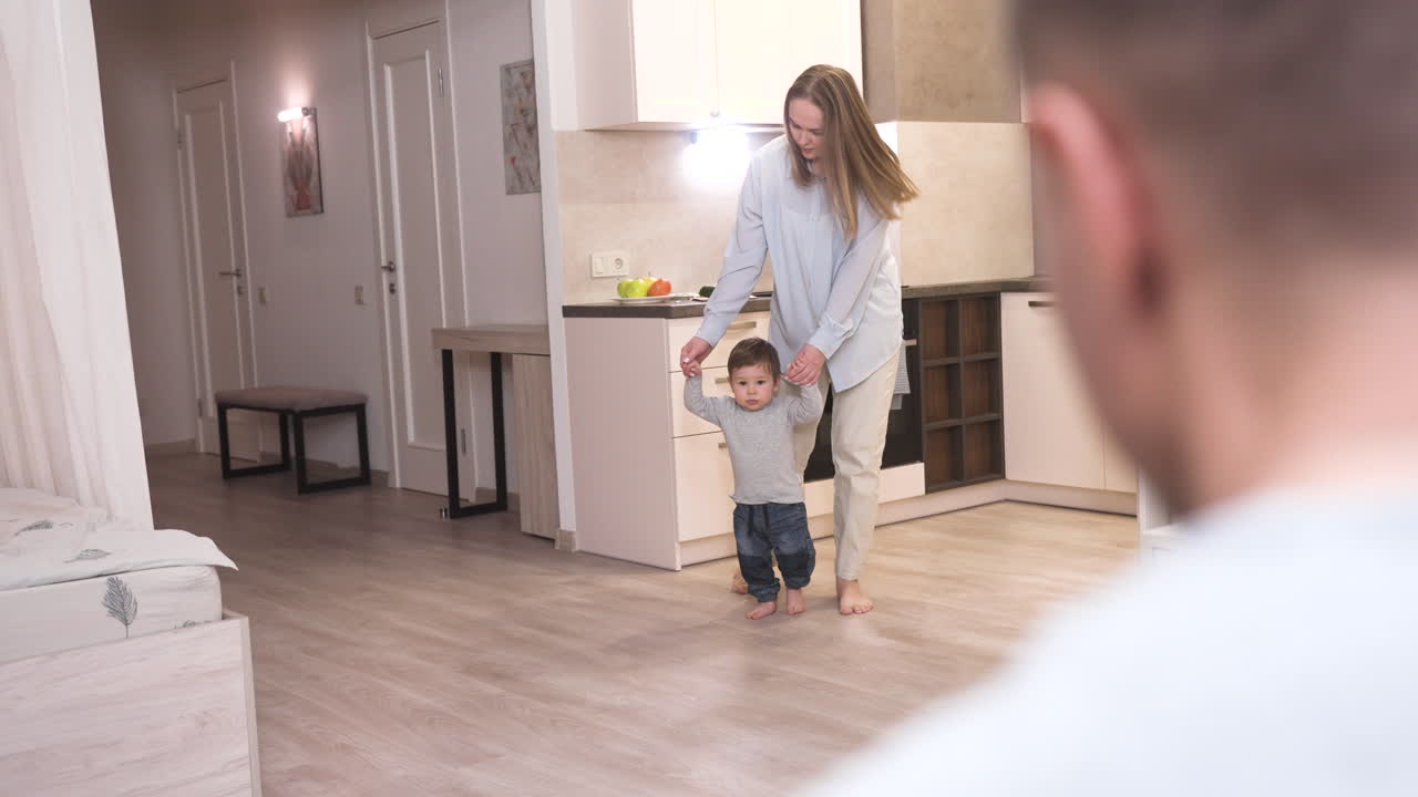 Rear View Of The Father Sitting On The Sofa At Home