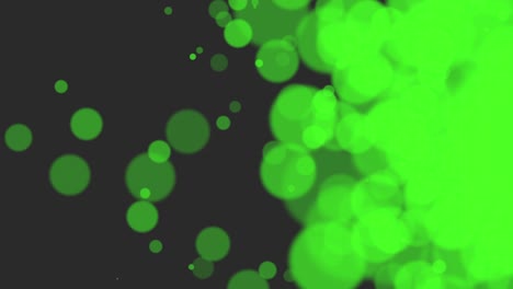 partículas verdes y bokeh redondo sobre fondo negro