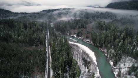 drone following car driving snowy mountain loop highway