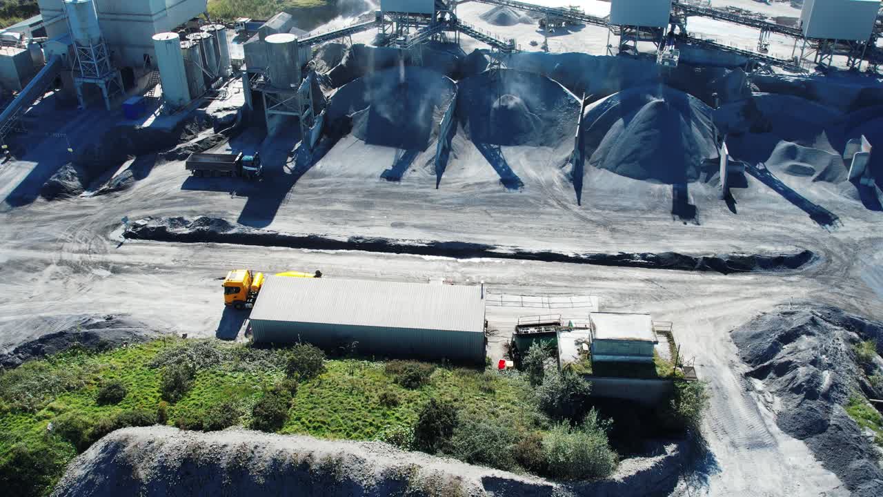Mining conveyer belt grading stone chipping in a working quarry graded chipping of limestone drone footage