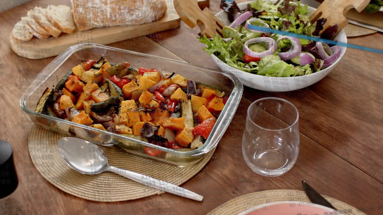 Camera starting slow pan revealing salad bowl, roasted veg, bread, chicken, showing table set