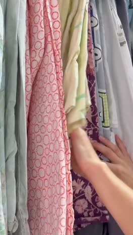 young woman shopping second hand. used clothes in the store.