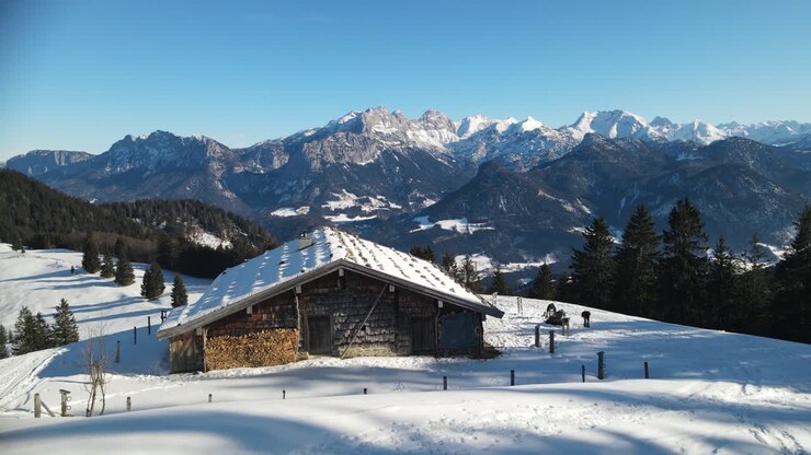 Apline wooden cottage in the mountains orbiting shot around cabin