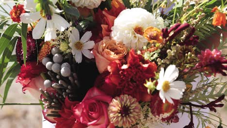 close up of bride in her wedding gown outdoors holding bouquet of colorful summer flowers 1080p 60fps