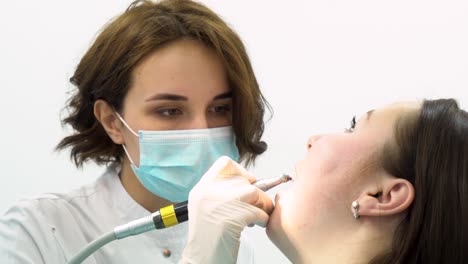 dentist performing a teeth cleaning procedure.