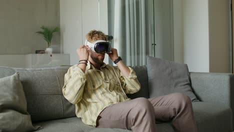 man wearing vr headset on a couch