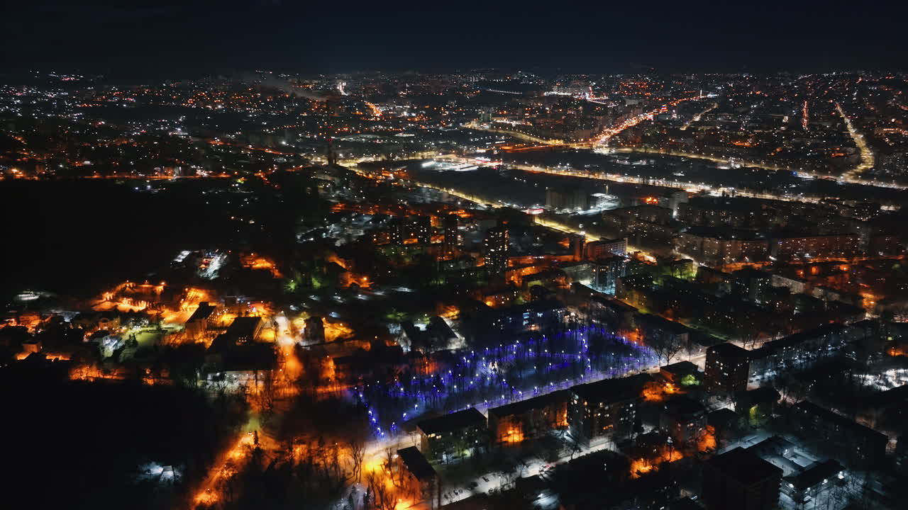Aerial drone view of Chisinau city covered in snow at night, blue hour. Moldova