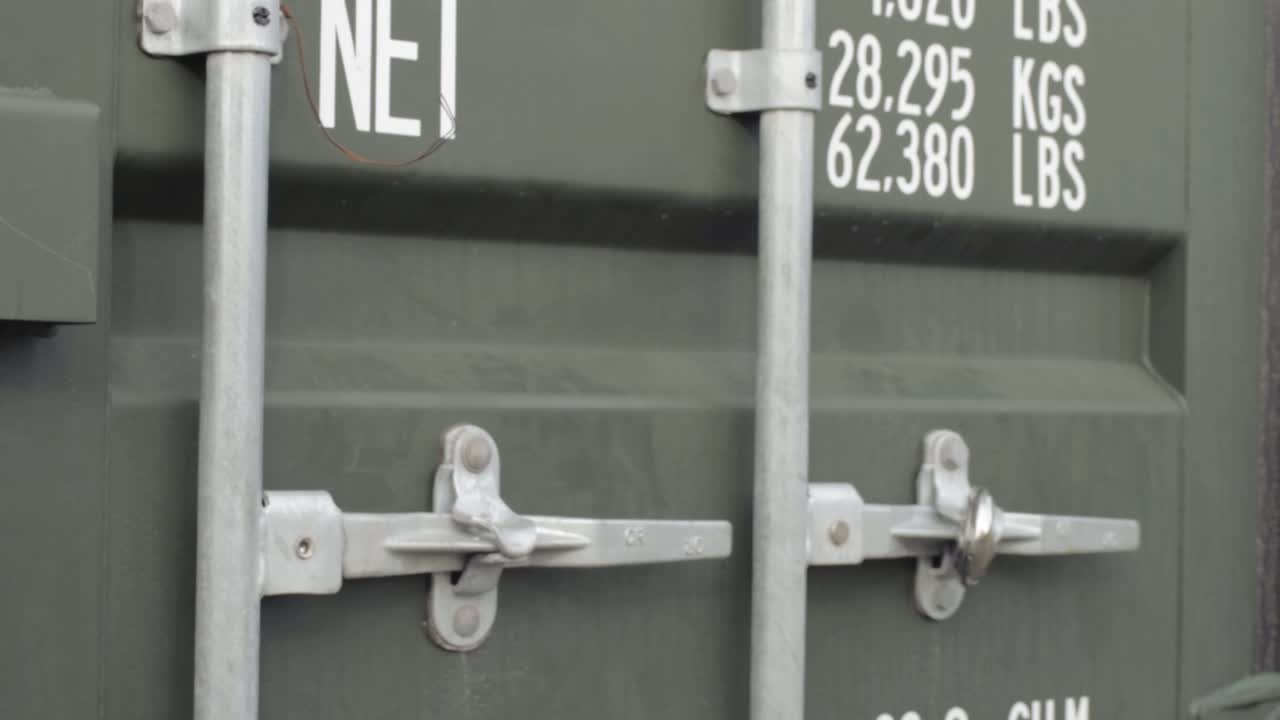 Shipping container green close up panning shot
