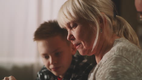 grandmother and grandson using a tablet