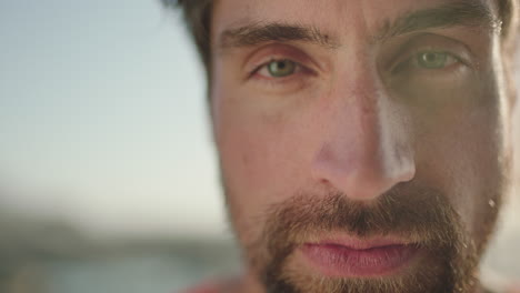 close up portrait of attractive young man staring intense looking pensive serious at camera