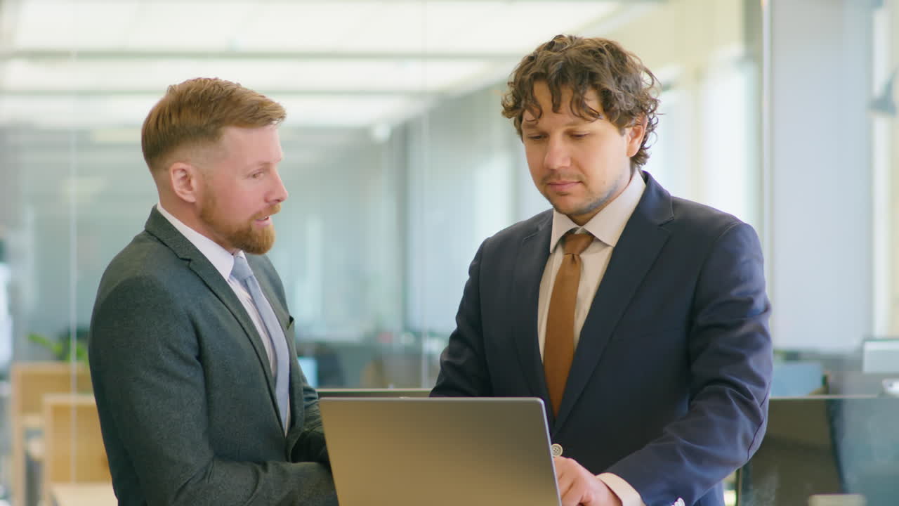 Colleagues Shaking Hands and Talking in Office